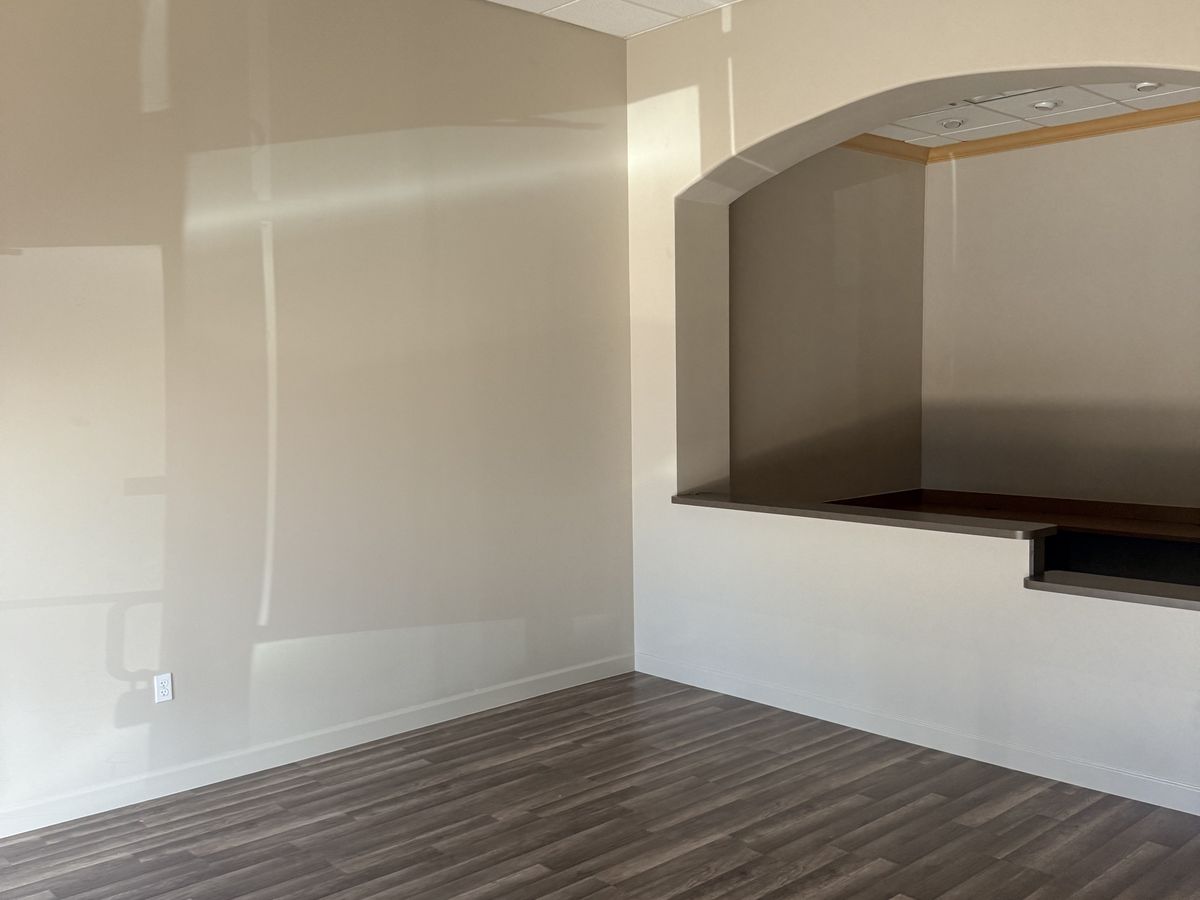 The same room finished with new luxury vinyl plank flooring and fresh neutral paint
