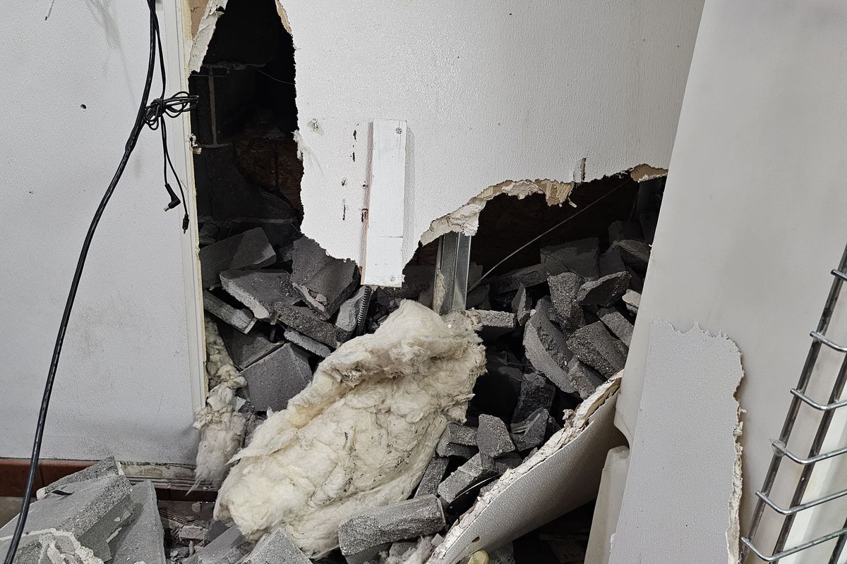 Interior kitchen wall destroyed by the impact, block and insulation on the floor