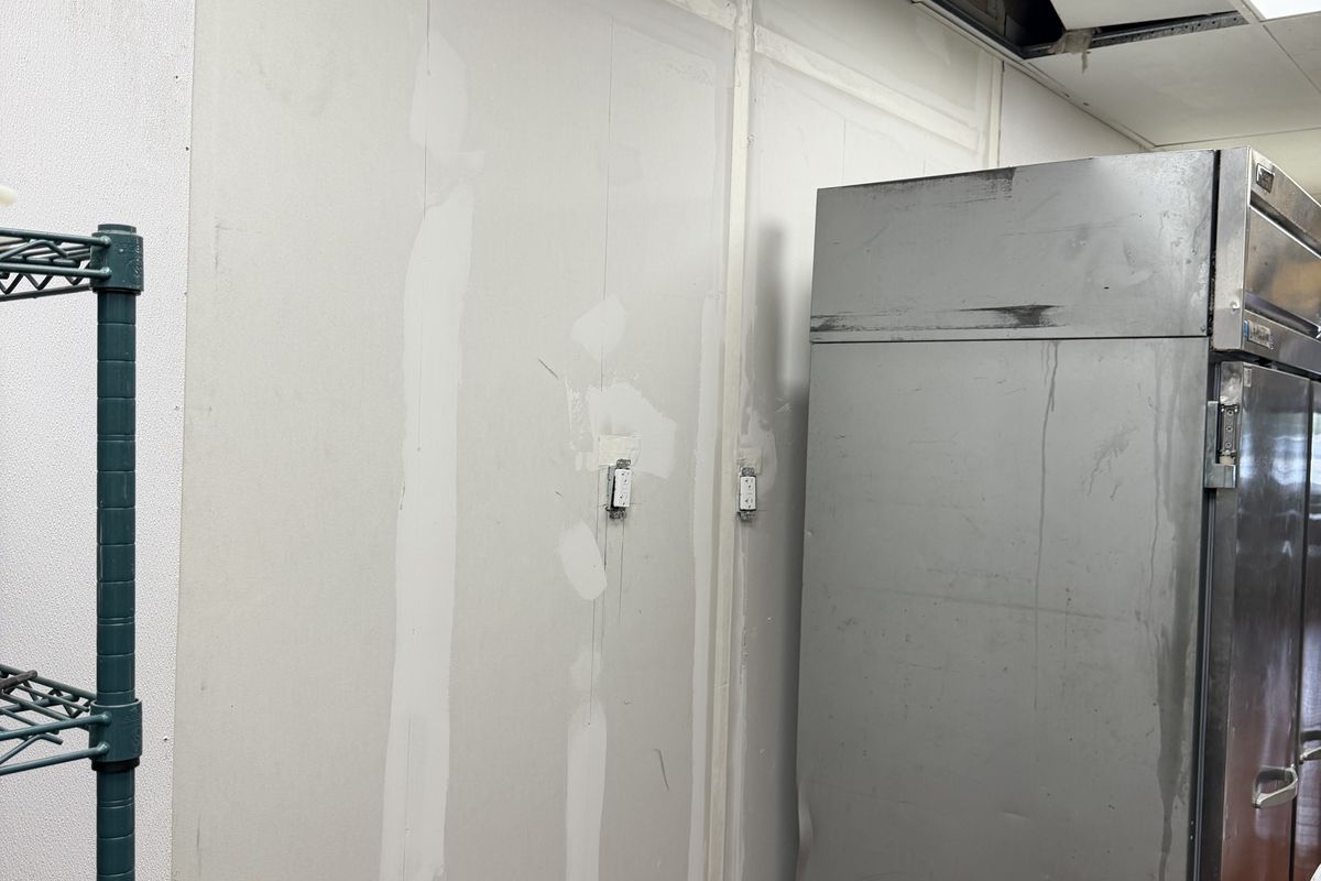 Finished interior wall with kitchen equipment back in place