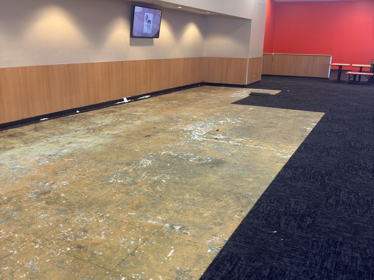 Restaurant dining room stripped to the bare slab before new flooring