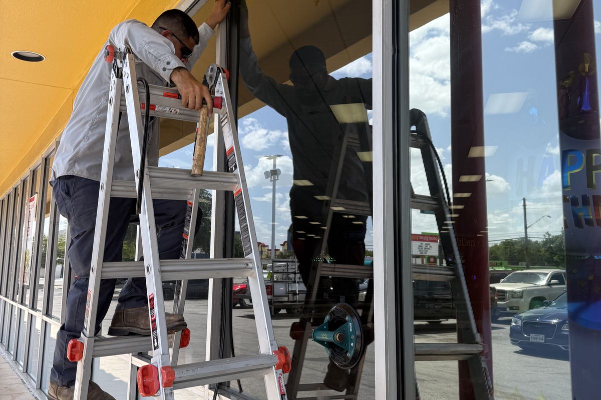 Storefront windows being reset and re-sealed